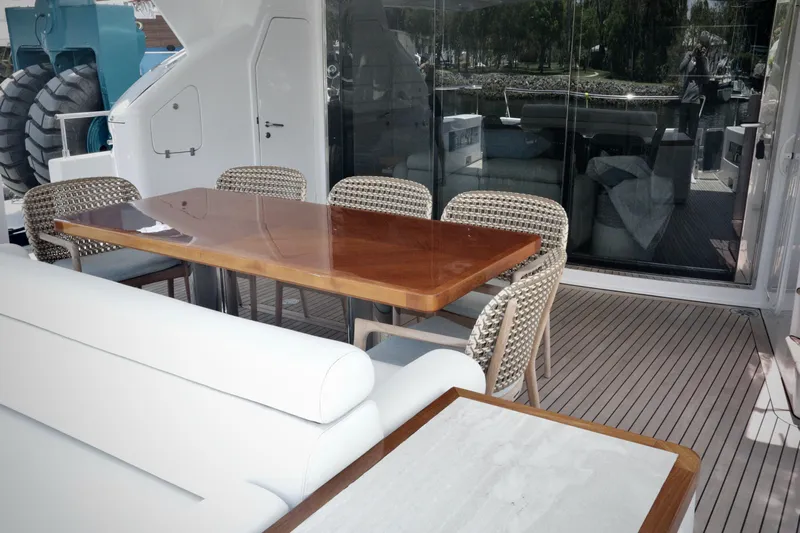  Yacht Photos Pics Luxurious outdoor dining area on a 2016 Custom Line 97 yacht with elegant seating.
