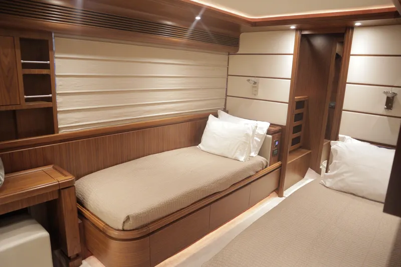  Yacht Photos Pics Luxurious cabin interior of 2016 Custom Line 97 yacht with elegant wood finishes.