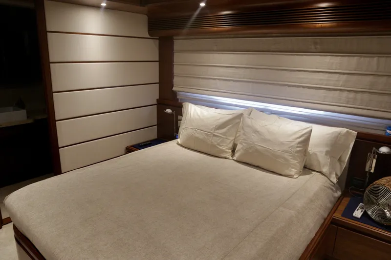  Yacht Photos Pics Luxurious bedroom interior of 2016 Custom Line 97 yacht with elegant bedding and ambient lighting.