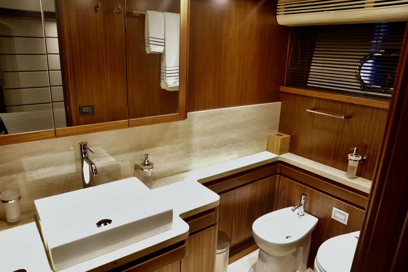  Yacht Photos Pics Luxurious bathroom in 2016 Custom Line 97 yacht, featuring modern fixtures and elegant wood finishes.