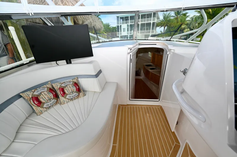  Yacht Photos Pics 2019 Intrepid 475 Sport Yacht interior with seating, TV, and cabin entrance.
