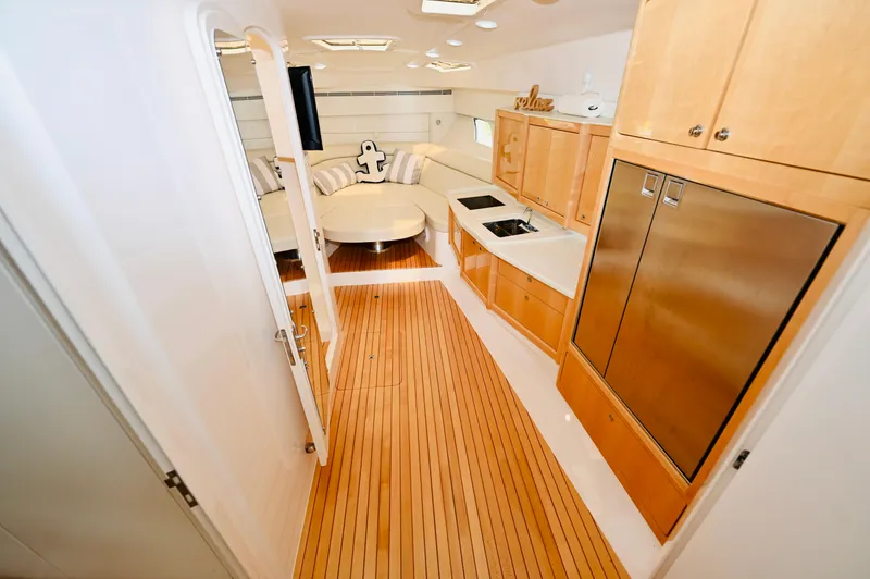  Yacht Photos Pics Interior of 2019 Intrepid 475 Sport Yacht with wooden flooring and modern kitchen amenities.