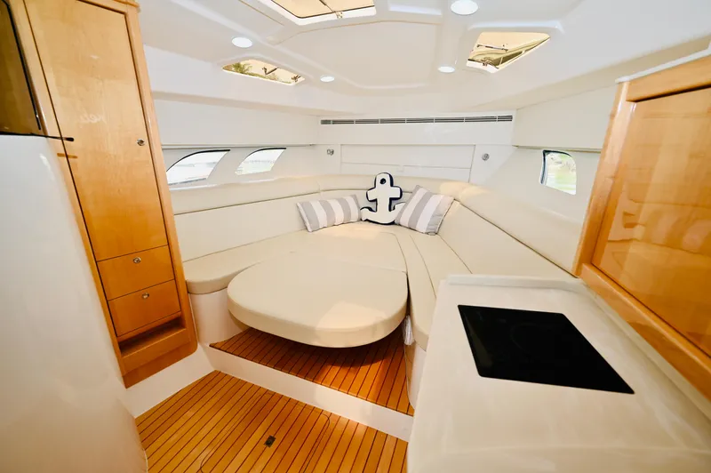  Yacht Photos Pics Interior of 2019 Intrepid 475 Sport Yacht with elegant seating and wooden flooring.