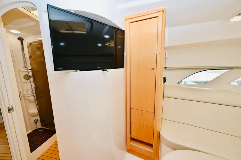  Yacht Photos Pics Interior of 2019 Intrepid 475 Sport Yacht with TV, shower, and seating area.