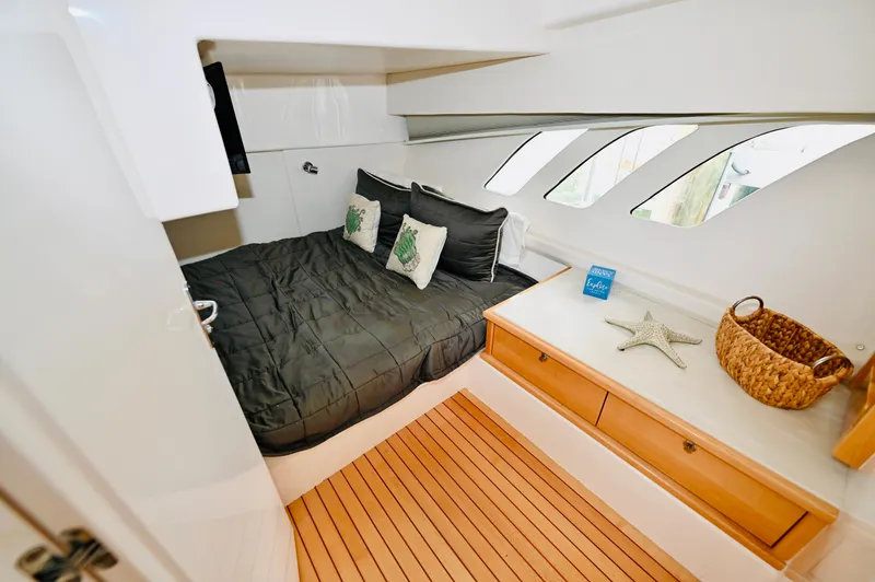  Yacht Photos Pics Luxurious cabin interior of 2019 Intrepid 475 Sport Yacht with bed and wooden flooring.