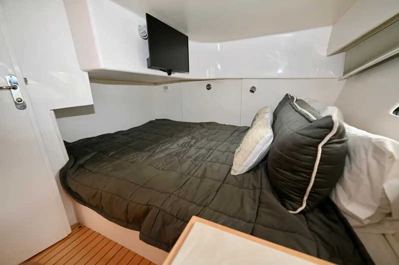  Yacht Photos Pics 2019 Intrepid 475 Sport Yacht cabin with bed, TV, and modern decor.