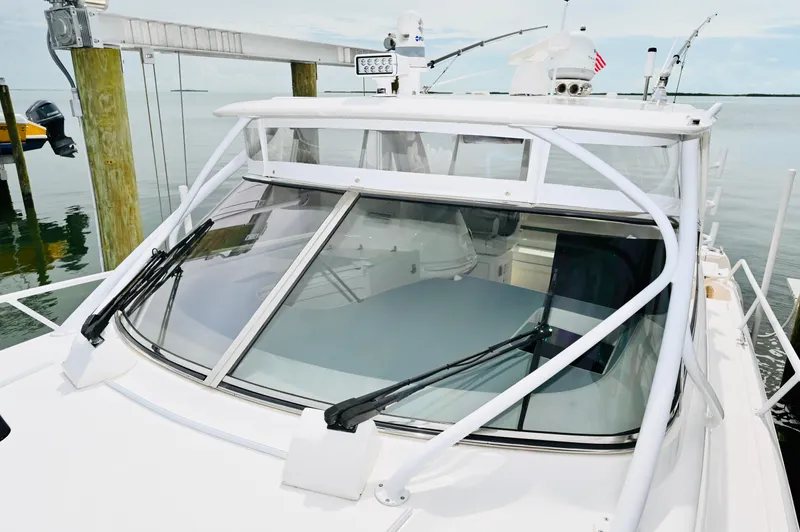  Yacht Photos Pics 2019 Intrepid 475 Sport Yacht docked, showcasing sleek windshield design and modern features.