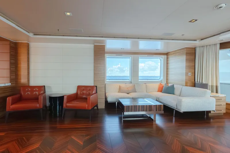 Superyacht W Yacht Photos Pics Luxurious Feadship motor yacht interior with modern seating, wood flooring, and ocean view windows.