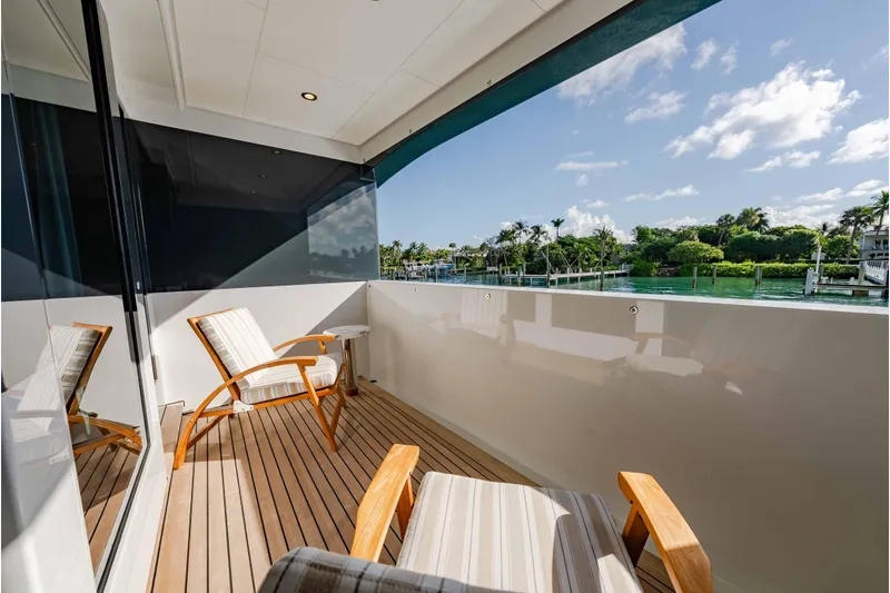 Superyacht W Yacht Photos Pics Luxurious deck of 2013 Feadship motor yacht with chairs, overlooking serene waterfront view.