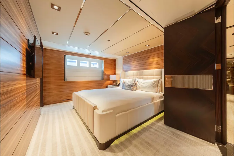 Superyacht W Yacht Photos Pics Luxurious bedroom interior on a 2013 Feadship motor yacht, featuring elegant wood paneling.