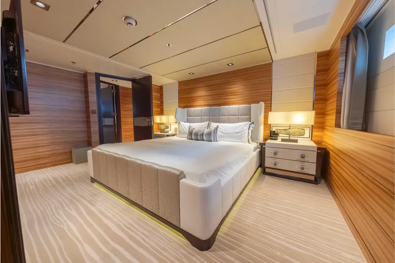 Superyacht W Yacht Photos Pics Luxurious bedroom interior on 2013 Feadship motor yacht, featuring elegant wood paneling and modern design.