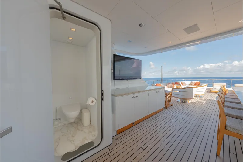 Superyacht W Yacht Photos Pics Luxurious 2013 Feadship motor yacht deck with seating, TV, and ocean view.
