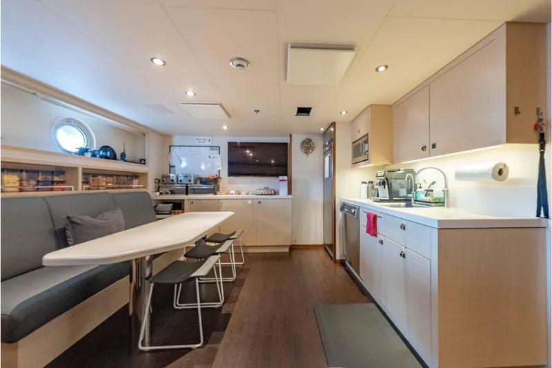 Superyacht W Yacht Photos Pics Modern kitchen interior on 2013 Feadship motor yacht, featuring sleek cabinetry and dining area.