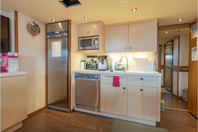 Superyacht W Yacht Photos Pics Modern kitchen interior on 2013 Feadship motor yacht, featuring stainless steel appliances and sleek cabinetry.