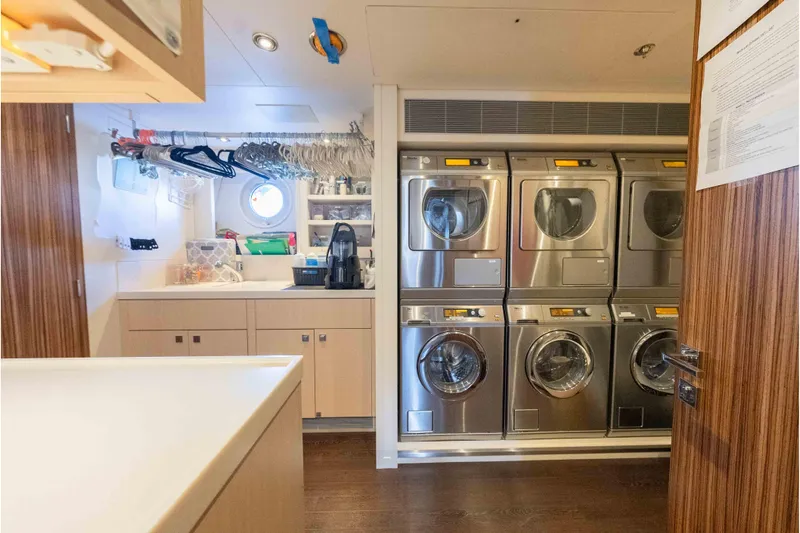 Superyacht W Yacht Photos Pics Laundry room on 2013 Feadship Motor Yacht with washers, dryers, and storage.