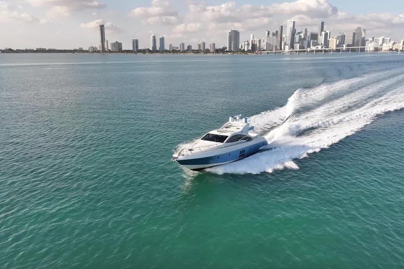  Yacht Photos Pics Azimut 68S yacht cruising near city skyline, 2006 model, clear blue waters.