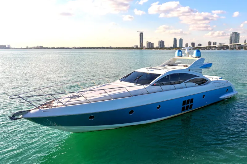  Yacht Photos Pics 2006 Azimut 68S yacht on calm water with city skyline in background.