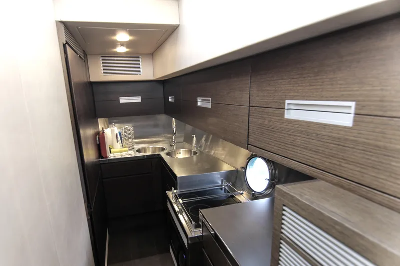  Yacht Photos Pics Modern kitchen interior of 2006 Azimut 68S yacht with sleek cabinetry and stainless steel fixtures.