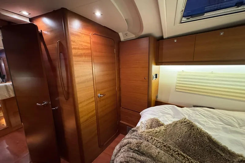 Nine Yacht Photos Pics Luxurious interior of 2016 Dufour 512 Grand Large yacht cabin with wood finish.