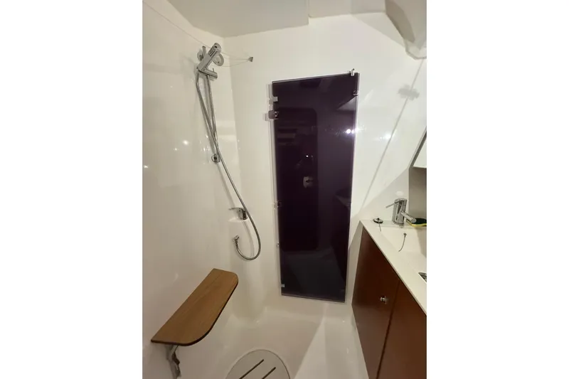 Nine Yacht Photos Pics Bathroom interior of 2016 Dufour 512 Grand Large yacht with shower and wooden seat.