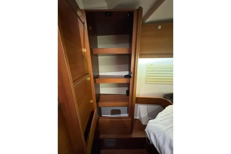 Nine Yacht Photos Pics Wooden interior of 2016 Dufour 512 Grand Large yacht cabin with shelving.