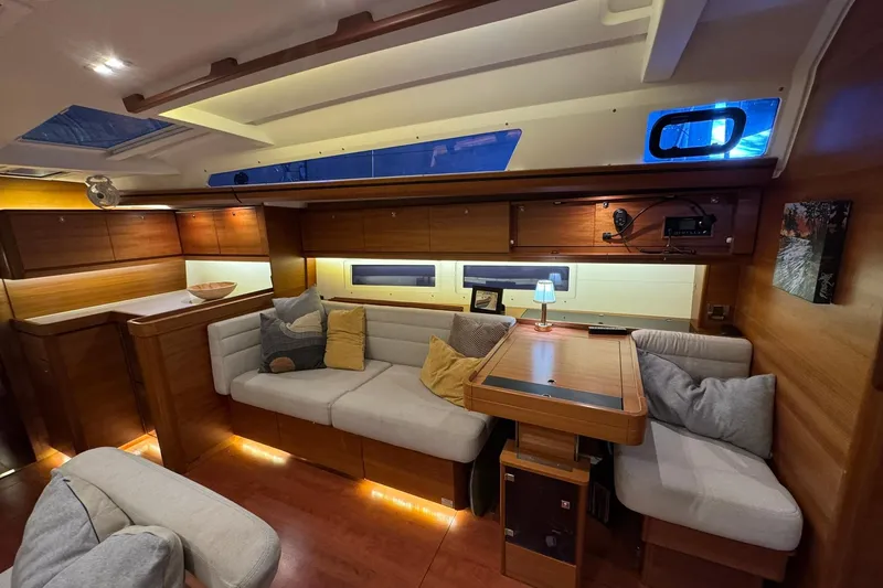 Nine Yacht Photos Pics Luxurious interior of 2016 Dufour 512 Grand Large yacht with cozy seating and ambient lighting.