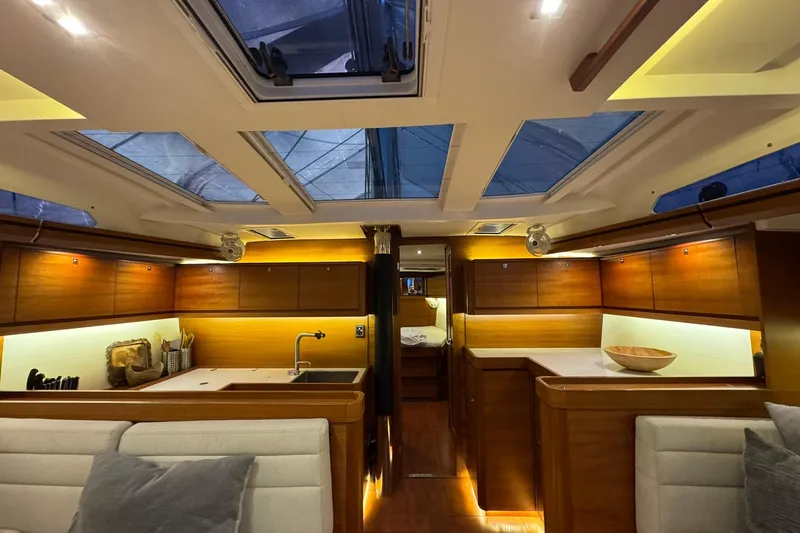 Nine Yacht Photos Pics Luxurious interior of 2016 Dufour 512 Grand Large yacht with modern kitchen and skylights.