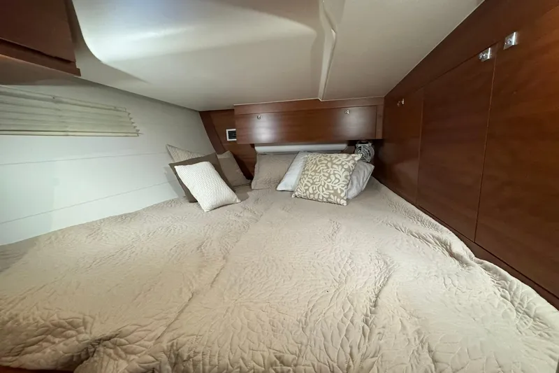 Nine Yacht Photos Pics Cozy cabin interior of 2016 Dufour 512 Grand Large yacht with plush bedding.