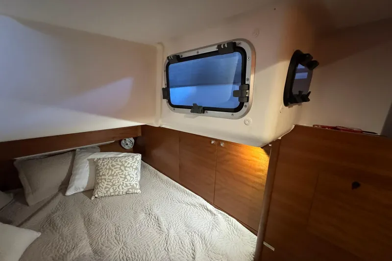 Nine Yacht Photos Pics Cozy cabin interior of 2016 Dufour 512 Grand Large yacht with window and bedding.