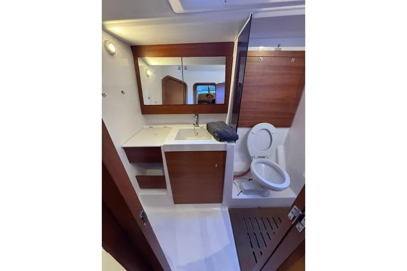 Nine Yacht Photos Pics Bathroom interior of 2016 Dufour 512 Grand Large yacht, featuring sink and toilet.