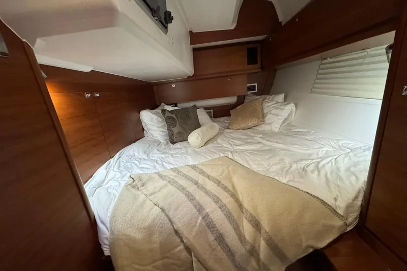 Nine Yacht Photos Pics Cozy cabin interior of 2016 Dufour 512 Grand Large yacht with plush bedding.