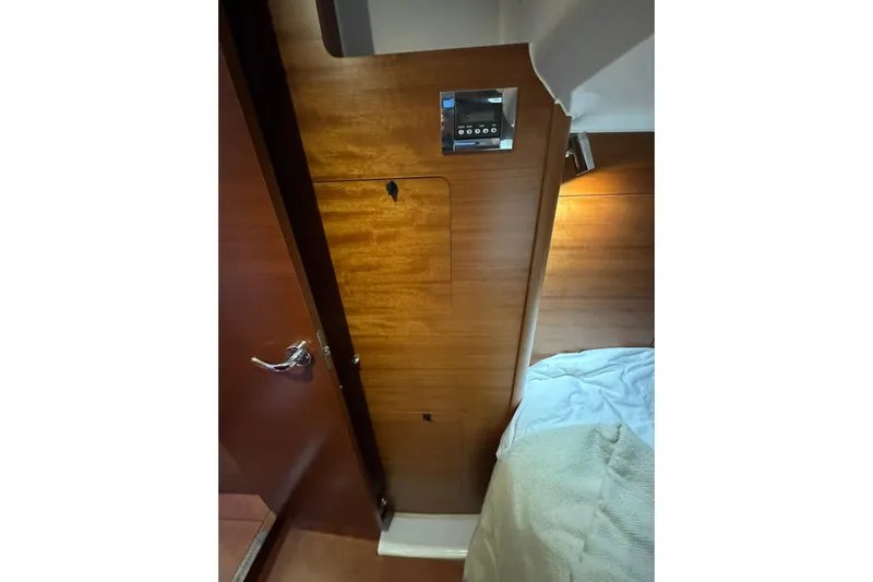 Nine Yacht Photos Pics Interior of 2016 Dufour 512 Grand Large yacht, featuring wooden paneling and a control panel.