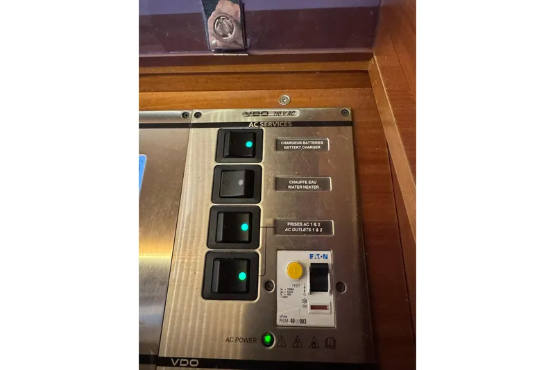 Nine Yacht Photos Pics Control panel of a 2016 Dufour 512 Grand Large yacht, featuring AC services switches.