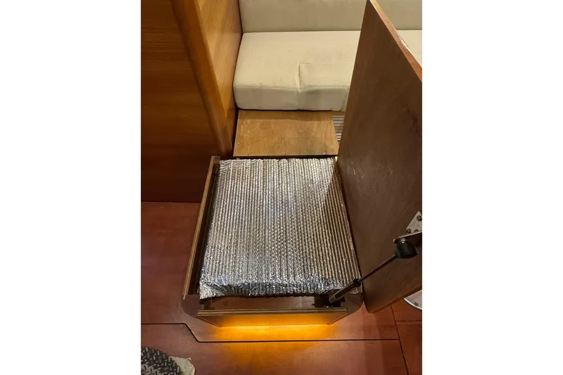 Nine Yacht Photos Pics Open storage compartment in 2016 Dufour 512 Grand Large yacht interior.