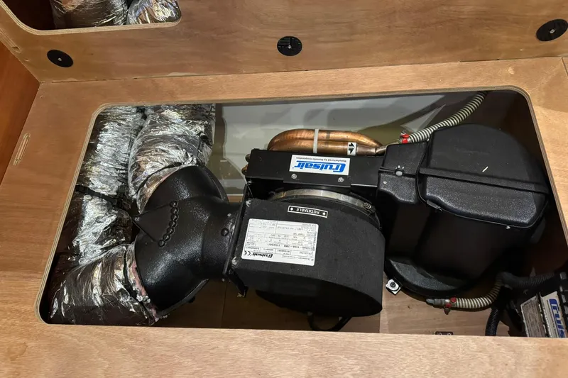 Nine Yacht Photos Pics Engine compartment of a 2016 Dufour 512 Grand Large yacht, featuring ductwork and machinery.