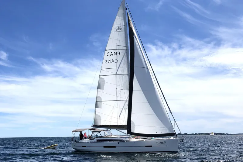 Nine Yacht Photos Pics 2016 Dufour 512 Grand Large sailing on open water under a clear blue sky.