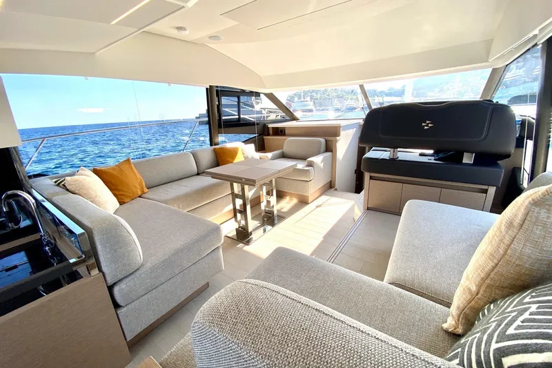 Amarsi Yacht Photos Pics Luxurious interior of 2023 Prestige 520 yacht with elegant seating and ocean view.