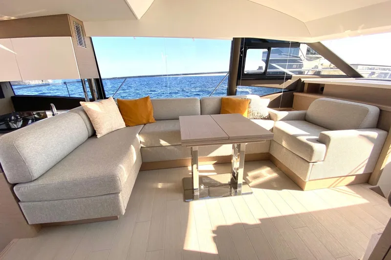 Amarsi Yacht Photos Pics Luxurious interior of 2023 Prestige 520 yacht with elegant seating and ocean view.
