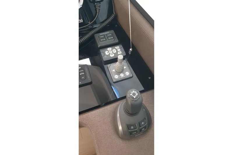 Amarsi Yacht Photos Pics Control panel of 2023 Prestige 520 yacht with joystick and buttons.
