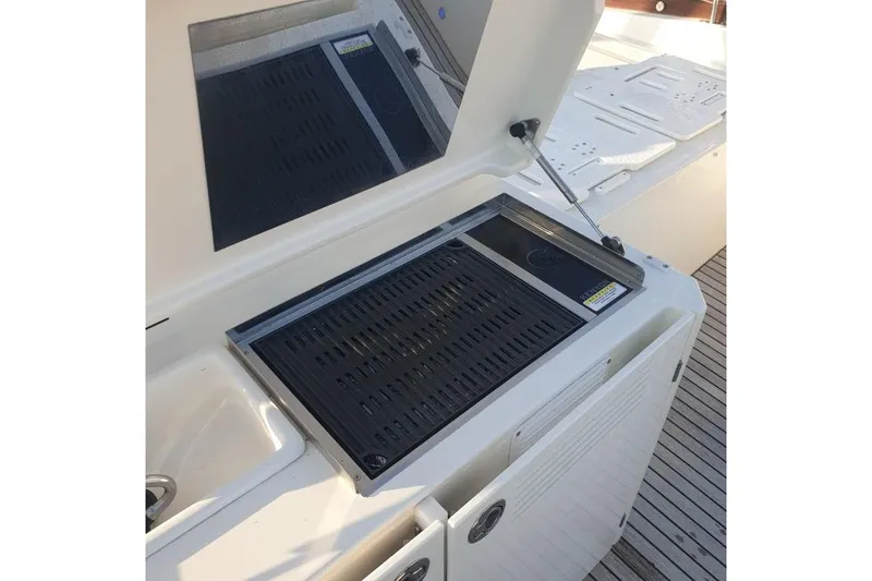 Amarsi Yacht Photos Pics Outdoor grill on 2023 Prestige 520 yacht deck, featuring sleek design and modern amenities.