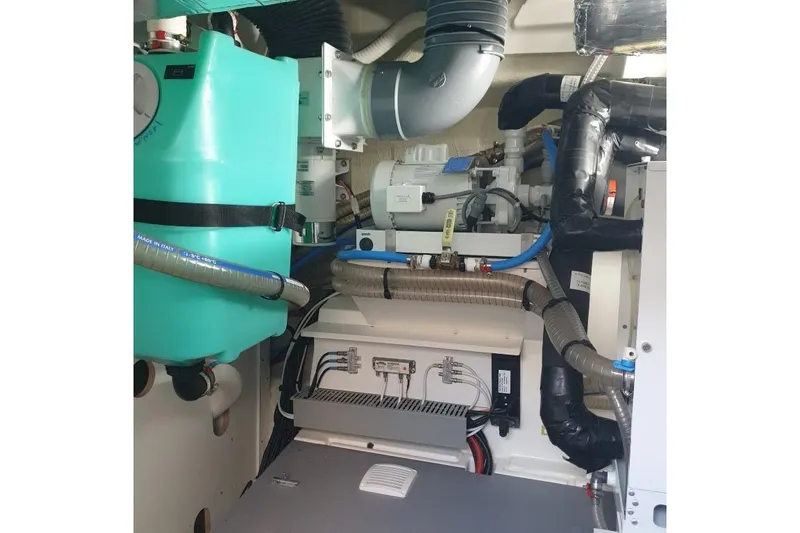 Amarsi Yacht Photos Pics Engine room of 2023 Prestige 520 yacht with complex mechanical systems and components.