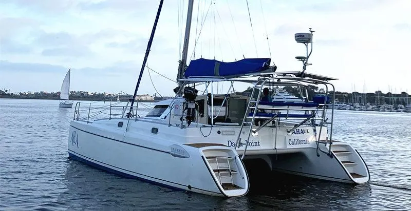 Aha Yacht Photos Pics 1997 Fountaine Pajot Tobago 35 catamaran sailing on calm waters.