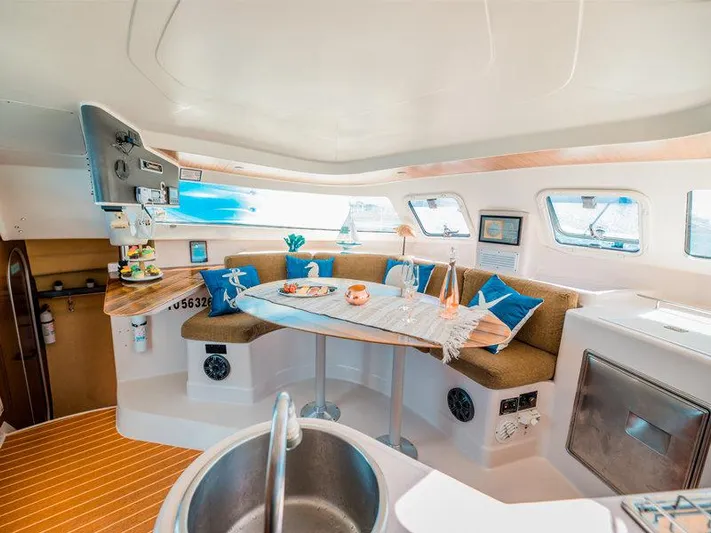 Aha Yacht Photos Pics Interior of 1997 Fountaine Pajot Tobago 35 catamaran with cozy seating and dining area.