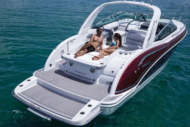 Gratitude Yacht Photos Pics Manufacturer Provided Image: 2015 Formula 350 Sun Sport boat with people relaxing on deck in clear blue water.