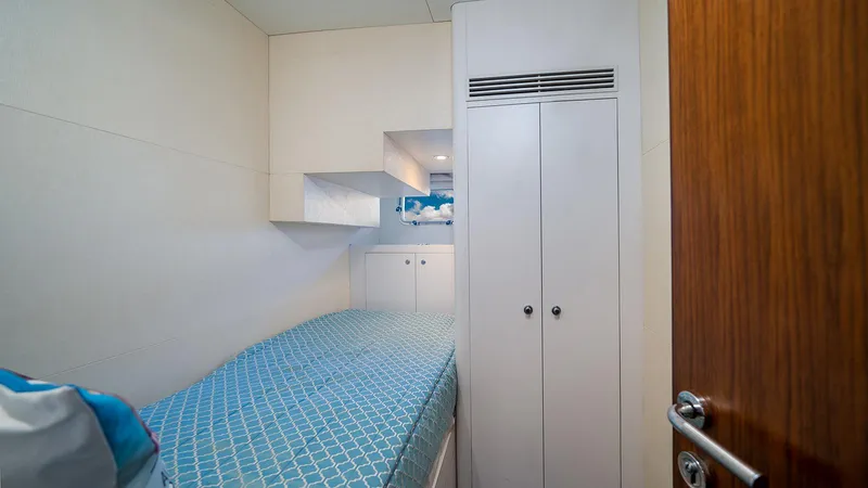 Sea N Sea Yacht Photos Pics Compact cabin interior of 2016 Ocean Alexander Skylounge yacht with single bed and storage.