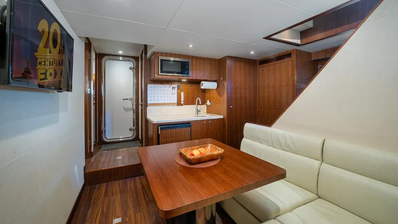 Sea N Sea Yacht Photos Pics Luxurious interior of 2016 Ocean Alexander Skylounge yacht with kitchenette and seating area.