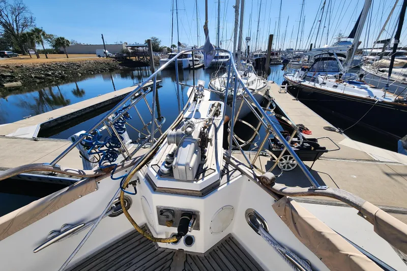 Part Of The Plan Yacht Photos Pics 1990 Grand Banks 46 Classic yacht docked at marina, surrounded by other boats.