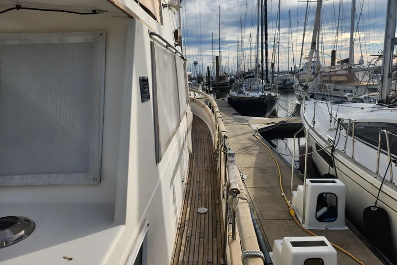 Part Of The Plan Yacht Photos Pics 1990 Grand Banks 46 Classic yacht docked at marina, surrounded by sailboats.