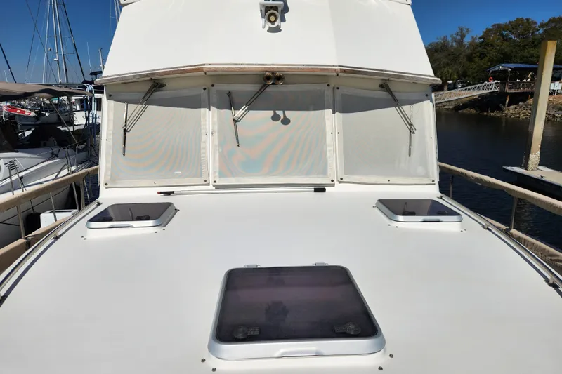 Part Of The Plan Yacht Photos Pics 1990 Grand Banks 46 Classic yacht deck with hatches, docked at marina.