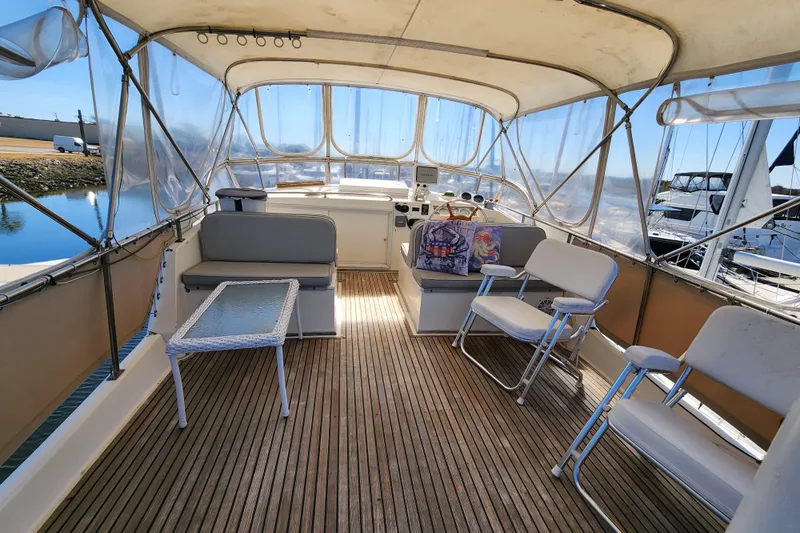 Part Of The Plan Yacht Photos Pics Spacious deck of 1990 Grand Banks 46 Classic yacht with seating and clear canopy.